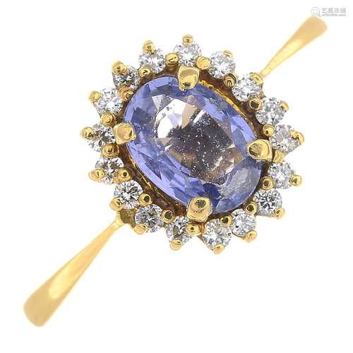 A sapphire and diamond cluster ring.Sapphire calculated weight 0.83ct,