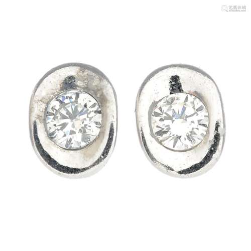 A pair of 18ct gold diamond earrings.Estimated total diamond weight 0.30ct,
