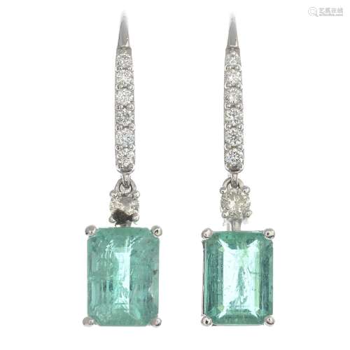 A pair of emerald and diamond drop earrings.Estimated total diamond weight 0.50ct.Stamped