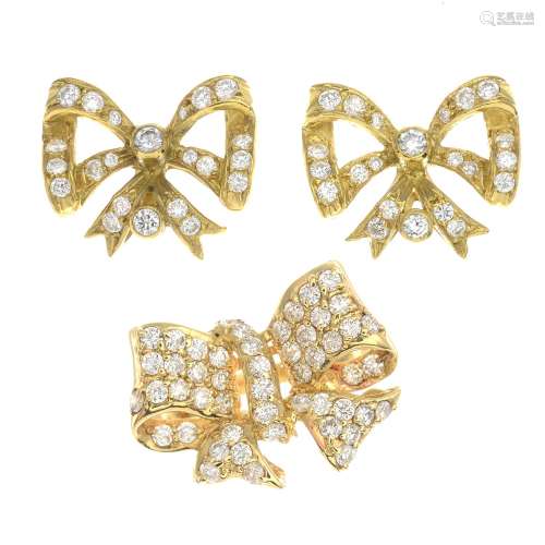 A pair of 18ct gold diamond bow earrings together with a similarly designed diamond ring.