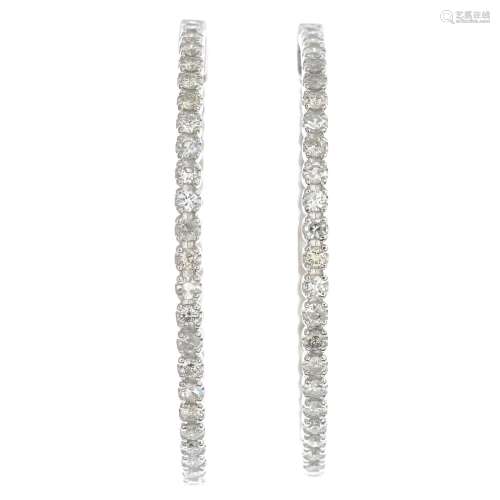 A pair of diamond hoop earrings.Estimated total diamond weight 1.35cts.Length 3.3cms.