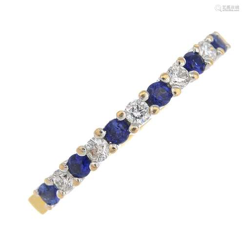 An 18ct gold sapphire and diamond half eternity ring.Hallmarks for Birmingham.Ring size K1/2.