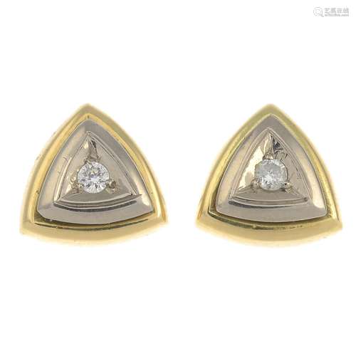 A pair of bi-colour diamond earrings.Estimated total diamond weight 0.13ct,