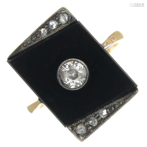 An onyx and diamond dress ring.Principal diamond estimated weight 0.20ct,