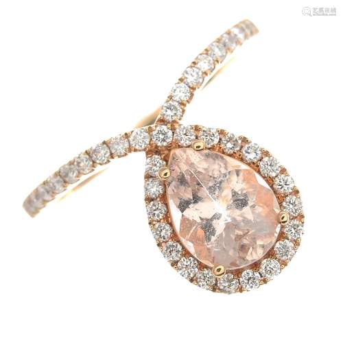 A morganite and diamond dress ring.Estimated total diamond weight 0.40ct.Stamped 750.Ring size M.