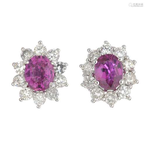 A pair of ruby and diamond cluster earrings.Ruby calculated weight 1.07cts,