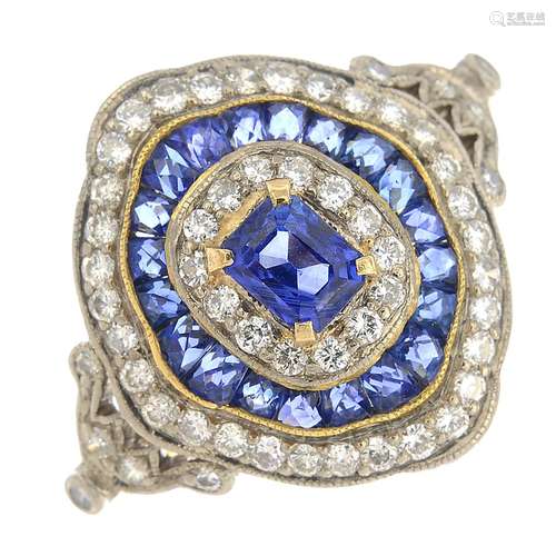 A sapphire and diamond cluster ring.Estimated diamond weight 0.50ct.Stamped 18k.Ring size M.