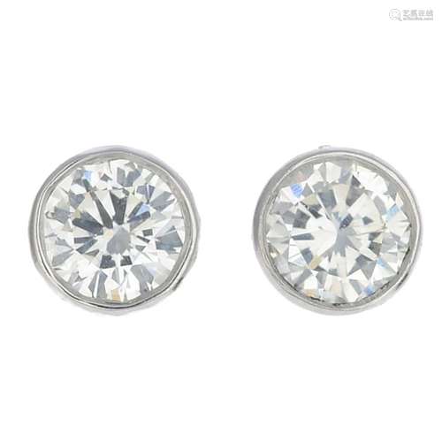 A pair of brilliant-cut diamond stud earrings.Estimated total diamond weight 0.40ct,