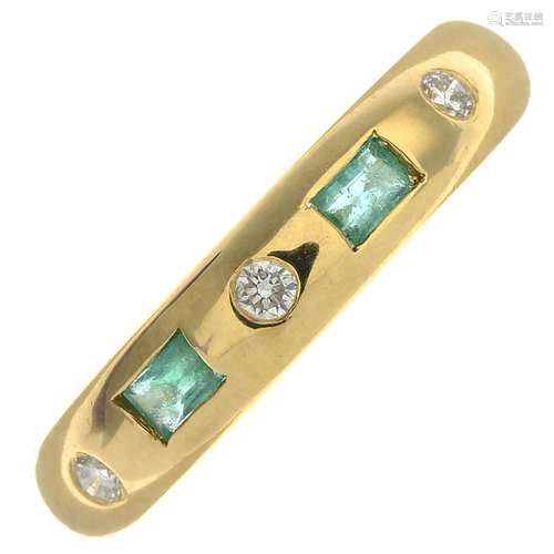 An 18ct gold emerald and diamond band ring.Estimated total diamond weight under 0.10ct.Hallmarks