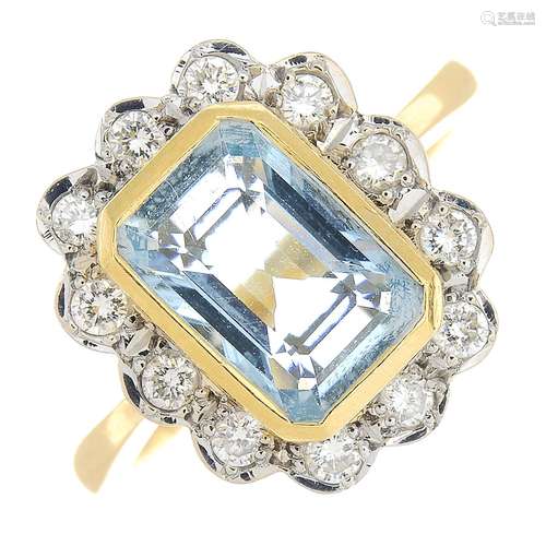 An 18ct gold aquamarine and diamond cluster ring.Aquamarine calculated weight 2.60cts,