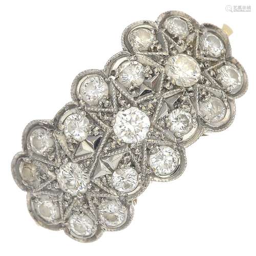 An 18ct gold diamond floral cluster ring.Estimated total diamond weight 0.70ct.Hallmarks for