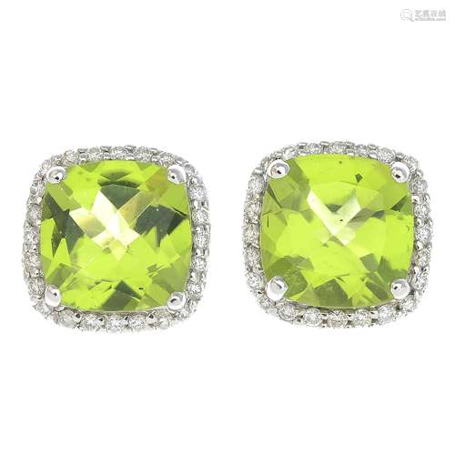 A pair of 18ct gold peridot and diamond earrings.Total peridot weight 4.09cts.Total diamond weight