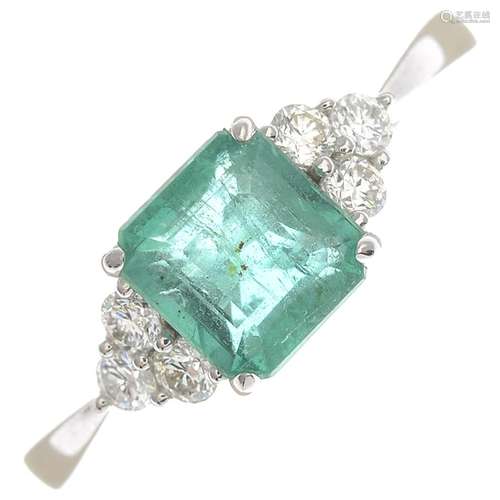 An emerald and diamond dress ring.Emerald calculated weight 0.95ct,