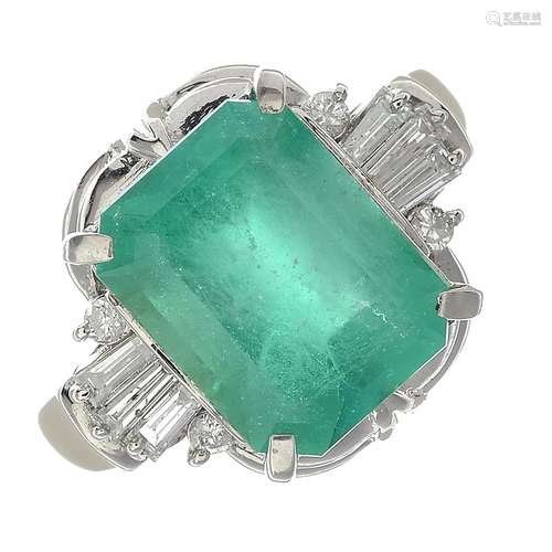 An emerald and diamond ring dress ring.Emerald weight 4.10cts,