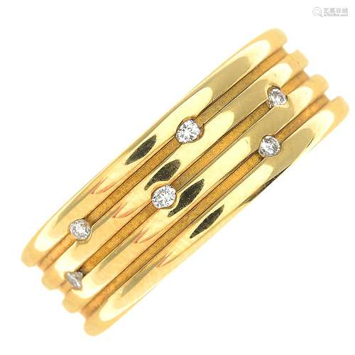 An 18ct gold diamond grooved band ring.Total diamond weight 0.06ct, stamped to band.