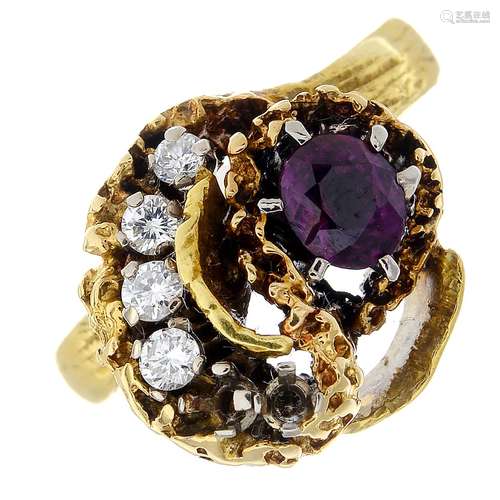 A 1970s garnet and diamond dress ring.Estimated total diamond weight 0.20ct.Ring size M.