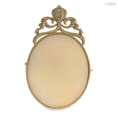 A 9ct gold opal and diamond pendant.May be worn as a brooch.Hallmarks for Sheffield,