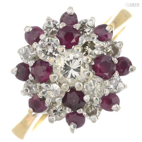 An 18ct gold ruby and diamond cluster ring.Estimated total diamond weight 0.65ct,