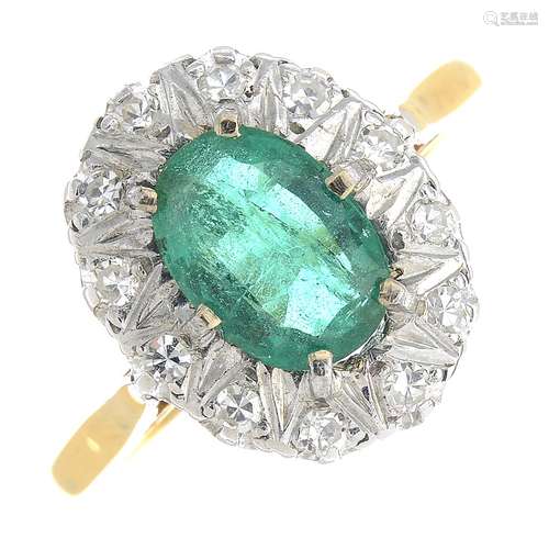 An 18ct gold emerald and diamond cluster ring.Emerald calculated weight 0.93ct,