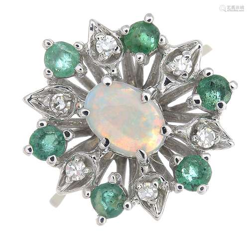 An opal, emerald and diamond cluster ring.Estimated dimensions of opal 6.9 by 4.7 by