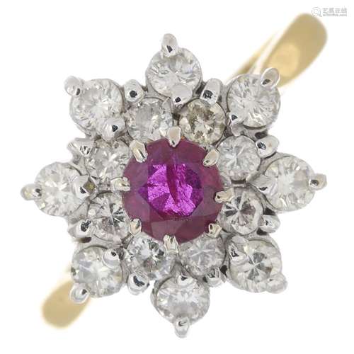 An 18ct gold ruby and diamond cluster ring.Estimated total diamond weight 0.45ct.Hallmarks for