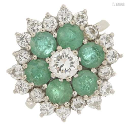 An 18ct gold emerald and diamond cluster ring.