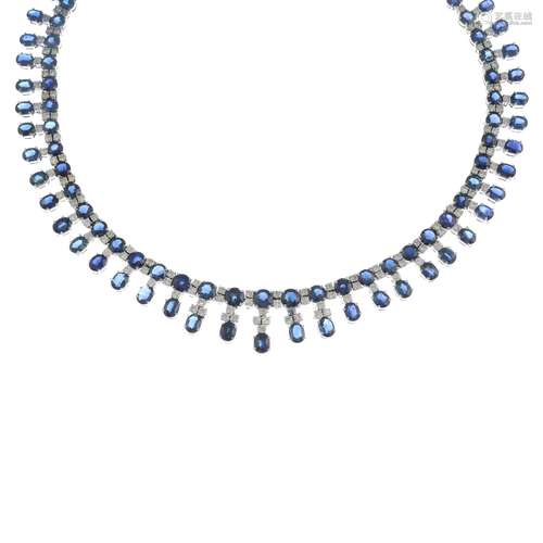 A sapphire and diamond fringe necklace.Estimated total diamond weight 6.50cts.Length 42.5cms.