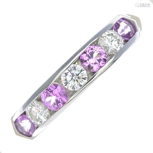 An 18ct gold pink sapphire and diamond half eternity ring.Estimated total diamond weight