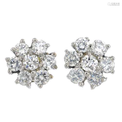 A pair of diamond cluster earrings.Estimated total diamond weight 1ct,