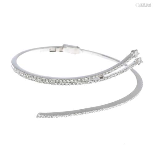 A diamond spray bangle.Estimated total diamond weight 1.50cts.Stamped 750.Inner diameter 5.6cms.