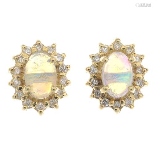 A pair of 14ct gold opal and diamond earrings.Estimated total diamond weight 0.15ct.Stamped