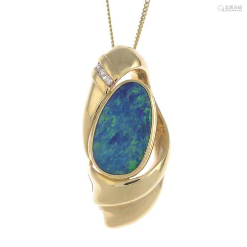 A 14ct gold boulder opal and diamond pendant, suspended from a chain.