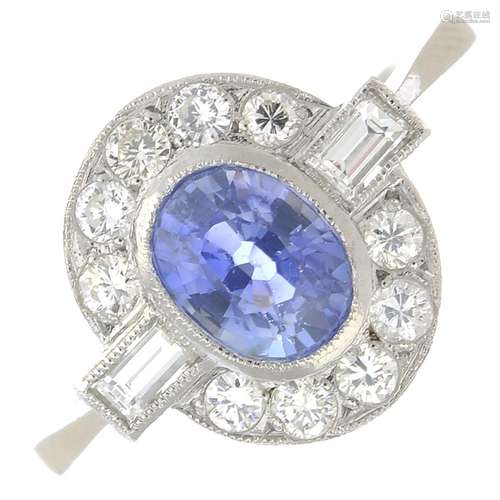 A sapphire and diamond cluster ring.Sapphire calculated weight 1.10cts,