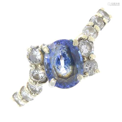 A 9ct gold sapphire and diamond crossover ring.Sapphire calculated weight 1.18cts,