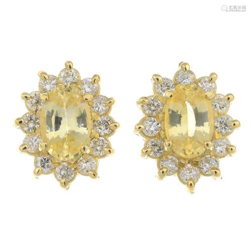 A pair of 18ct yellow sapphire and diamond cluster earrings.Estimated total diamond weight