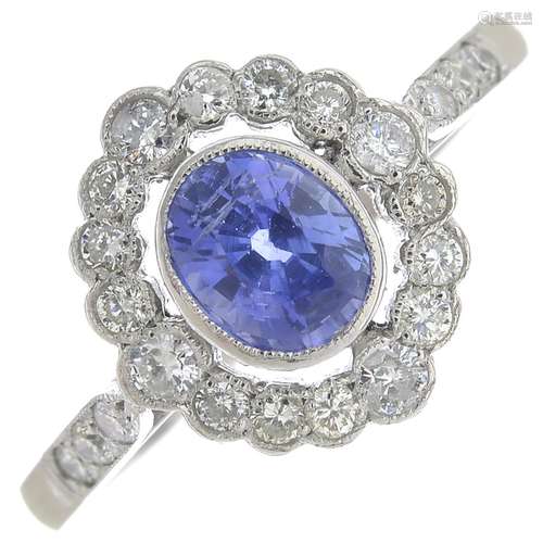 A sapphire and diamond cluster ring.Sapphire salculated weight 1ct,