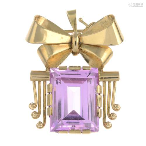 A 14ct gold synthetic pink sapphire bow brooch.May be worn as a pendant.Hallmarks for