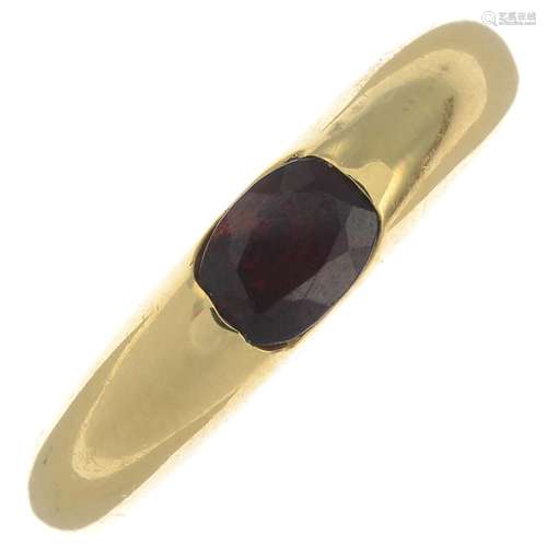 A garnet single-stone ring.