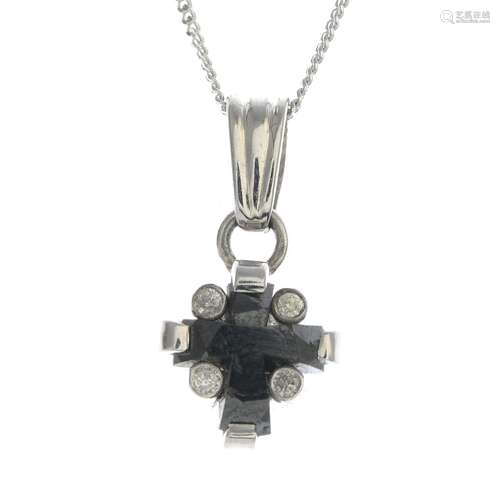 An 18ct gold black gem and diamond pendant,