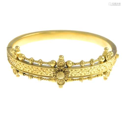 A late 19th century gold hinged bangle.Inner diameter 5.8cms.