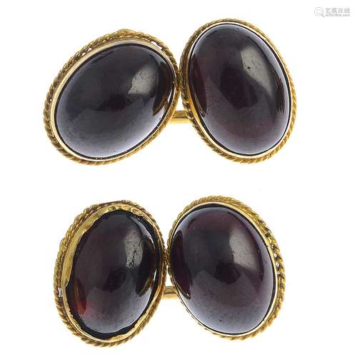 A pair of early 20th century gold garnet cufflinks.Length of cufflink face 1.2cms.