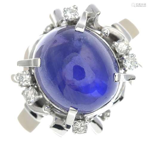 A sapphire cabochon and diamond dress ring.Sapphire calculated weight 10.20cts,