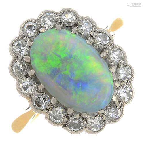 An opal and diamond cluster ring.Opal weight 1.77cts.Estimated total diamond weight 0.40ct.Stamped