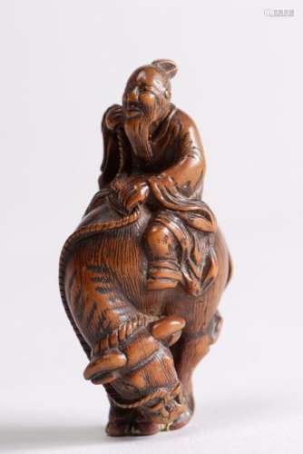 Netsuke en bois représentant Rôshi chevauchant un …