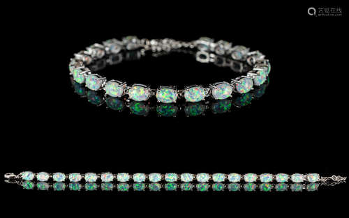 A Contemporary Silver And Opal Set Tennis Bracelet - Comprising 19 Oval Cabochon Opals. Of