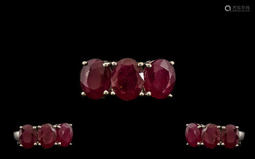 Ruby Three Stone Ring, a trilogy of rubies of good colour, totalling 5.5cts, set in a row, in