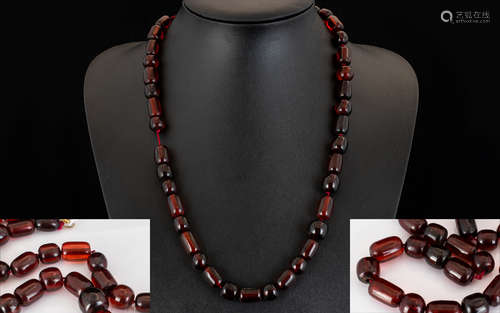 Cherry Amber/Bakelite Necklace. Early 20th century necklace with yellow metal clasp, length 24