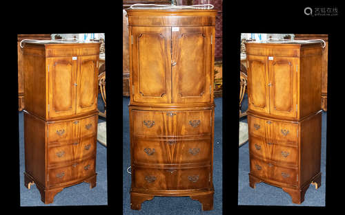 A Modern 20thC Mahogany Bow Fronted Cocktail Cabinet, the top with two shelves and a frieze drawer