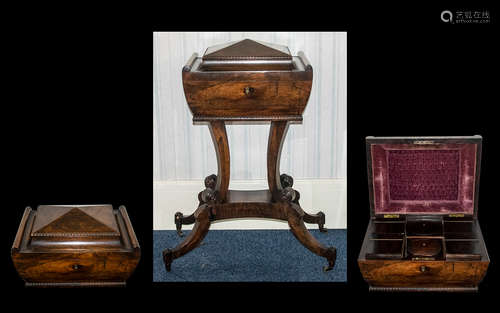 A Victorian Teapoy in rosewood. The top opens to reveal a sectioned interior and two mixing bowls