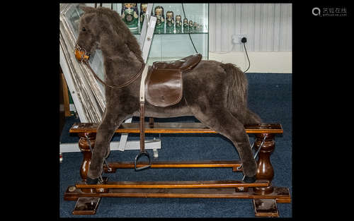 A Silver Cross Velour Covered Rocking Horse with a H swing crane. Plaque marked 'Modern British